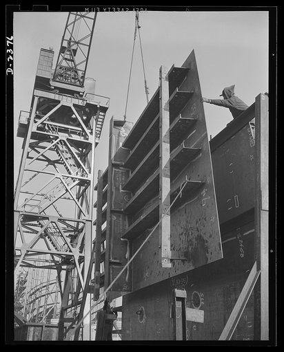Shipbuilding. "Liberty" ships. All assembled and ready to go in place. Prefabrication of sections such as this in a nearby plant formerly making freight cars saves weeks in the building of ships for Uncle Sam's new merchant fleet. This piece is being hoisted into place, and soon the welder will begi