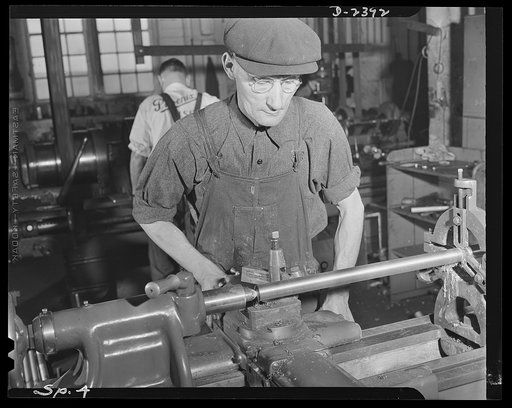 Conversion. Merry-go-round plant. These hands used to turn out merry-go-rounds to gladden the hearts of the nation's children. The carrousel plant in which they work is now engaged in producing war parts on subcontracts from army and navy contractors. Joe Wiegand is the machinist shown above, turnin