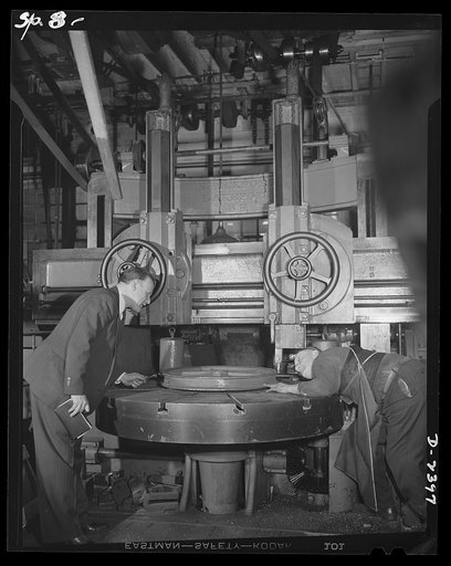 Conversion. Merry-go-round plant. These hands and this machine used to turn out merry-go-rounds to gladden the hearts of the nation's children. The carrousel plant in which they work is now engaged in producing war parts on subcontracts from army and navy contractors. While a plant officer looks on,