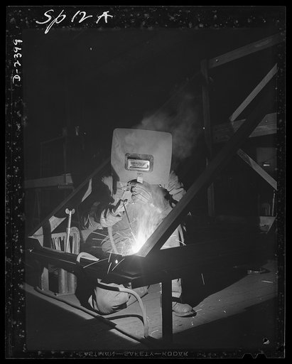 Conversion. Merry-go-round plant. John Brown used to weld rails for merry-go-round. The carrousel plant in which he worked is now engaged in producing parts for a war production program under several subcontractors. He finds the transition to the welding of steel shipping frames for airplane motors 