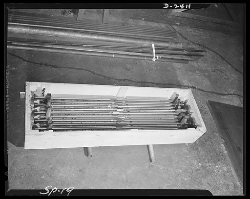 Conversion. Merry-go-round plant. These are shell ejectors for naval guns, a far cry from the peacetime product of the plant where they were turned out. This plant in New York state formerly made merry-go-rounds and other thrill rides, today it aids in the war effort, protecting the right of America