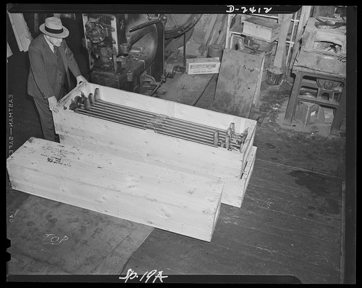 Conversion. Merry-go-round plant. Crated for shipment these shell ejectors for six-inch forty-seven caliber naval guns are a far cry from the peacetime production of the merry-go-round plant in which they were made. These plants have temporarily shelved its production of amusements devices to do its