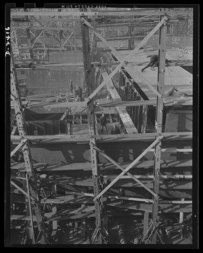 Shipbuilding. "Liberty" ships. This is the midship section of a new member of the Liberty Fleet, nearing completion at a large Eastern shipyard. In the background is a maze of scaffolding and cranes typical of the scene in many large American shipyards as builders work to make Uncle Sam master of th