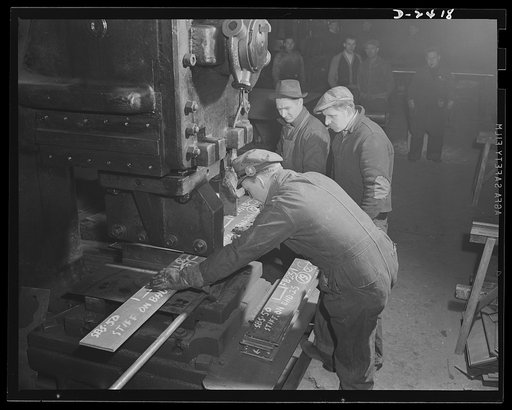 Shipbuilding. "Liberty" ships. Workers at a prefabricating plant turn out steel parts for a large Eastern shipyard building units of Uncle Sam's "Liberty Fleet." Here they operate a giant shear. This plant was originally used to produce freight cars, and the shears are part of the plant's original e