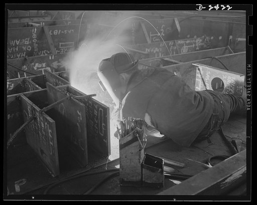 Shipbuilding. "Liberty" ships. Welding is more important than ever before in shipbuilding, saving time, weight and steel. This work is done at a nearby plant which formerly turned out freight cars. These workers are doing a dual welding operation on fuel oil tanks for the bottom of a "Liberty Ship" 