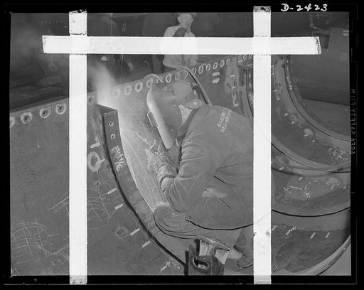 Shipbuilding. "Liberty" ships. Welding is more important than ever before in shipbuilding, saving time, weight and steel. This work is done at a nearby plant which formerly turned out freight cars. This worker is welding top plates to angle frames for a merchant ship under construction at a large Ea