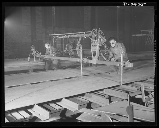 Shipbuilding. "Liberty" ships. This is a travograph-oxy-acetylene machine, a cutter which treads its own pattern. Here it is cutting two identical floor plates for a tank section at the bottom of a new member of the "Liberty Fleet." The work is done at what was formerly a freight car plant now a lar