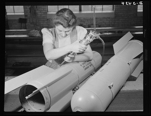 Conversion. Toy factory. With this same electric screwdriver, Stephanie Cewe used to work on the manufacture of toy trains. Now she's using it in far more important work--that of assembling flare casings. A. C. Gilbert Company, New Haven, Connecticut