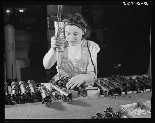 Conversion. Toy factory. From toy trains to parachute flare casings is the work history of Stephanie Cewe, whose skill with this electric screwdriver has been turned to the aid of Uncle Sam's war machine. Here she is shown at her former job--assembling locomotives for toy trains. Today she operates 