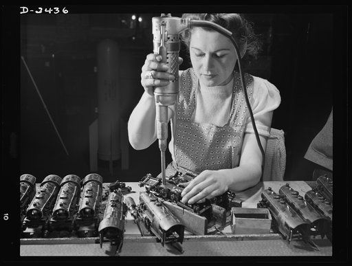 Conversion. Toy factory. From toy trains to parachute flare casings is the work history of Stephanie Cewe, whose skill with this electric screwdriver has been turned to the aid of Uncle Sam's war machine. Here she is shown at her former job--assembling locomotives for toy trains. Today she operates 
