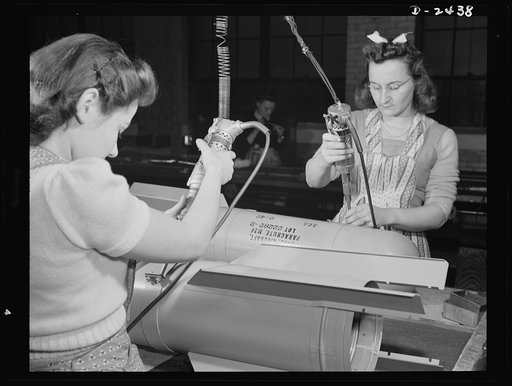 Conversion. Toy factory. Stephanie Cewe and Ann Manemeit, have turned their skill from peacetime production of toy trains to the assembly of parachute flare casings for the armies of democracy. Along with other workers in this Eastern plant, they have turned their skill to the vital needs of the day