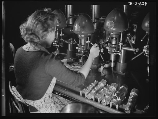 Conversion. Toy factory. Lucille Ciecko is one of the thousands of workers turning their skill today to the production of vital parts of Uncle Sam's war machine. Here she is shown at her peacetime work, drilling castings for toy locomotives in a large Eastern plant. Today she uses the same press, wi