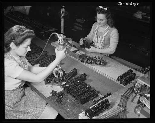 Conversion. Toy factory. These two girls, Stephanie Cewe and Ann Manemeit, have turned their skill from peacetime production of toy trains to the assembling of parachute flare casings for the armies of democracy. Along with other workers in this Eastern plant, they have turned their skill to the vit