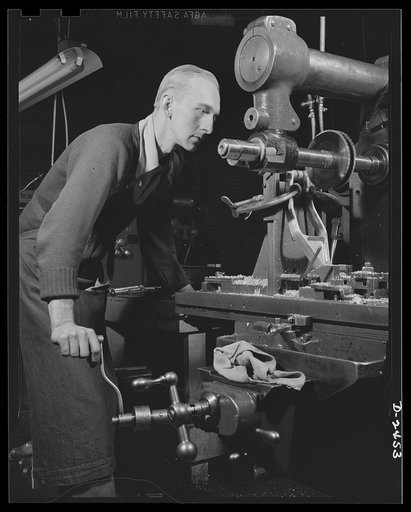Conversion. Floor waxer plant. Erstwhile elevator operator, this employee of a small Eastern plant finds a touch of similarity between levers of the old job and the new. But he's one of America's war production workers now, due to the company's subcontract for war production. Floorola Products Inc.,