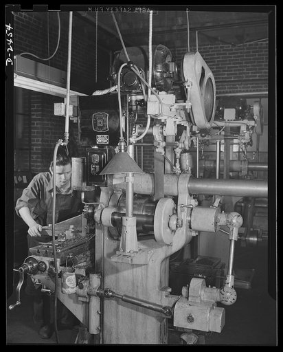 Conversion. Floor waxer plant. Now making machine-gun cover plates, this machine was converted from a line shaft drive to motor drive when a small Eastern manufacturing company converted its product from floor waxers to small parts for war equipment. Unable to purchase new equipment for his defense 