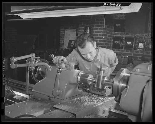 Conversion. Floor waxer plant. Through the skill and ingenuity of the entire personnel of this small Eastern manufacturing firm, machinery formerly used in production of floor waxers has been converted to production of war essentials. Pictured here is the night foreman employed by the company for fi