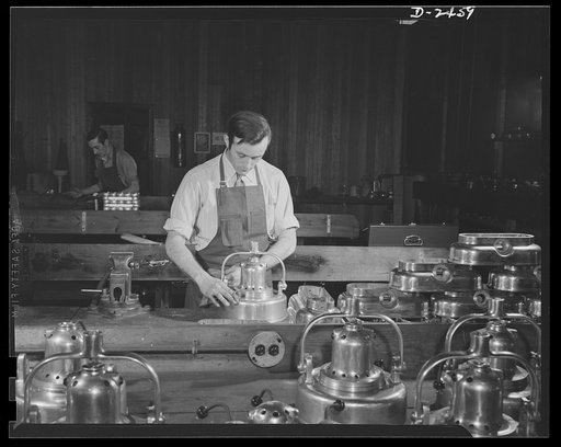 Conversion. Floor waxer plant. He used to be a weaver and repair man for looms, but he's one of Uncle Sam's defense workers now. Employed by a small Eastern floor waxer manufacturing firm, this worker now spends ninty-nine percent of his time working on small parts for gun mounts. Here, however, he'