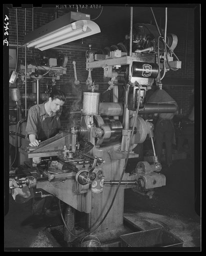 Conversion. Floor waxer plant. Now making machine gun cover plates, this machine was converted from a line shaft drive to motor drive when a small Eastern manufacturing company converted its product from floor waxers to small parts for war equipment. Unable to purchase new equipment for his defense 