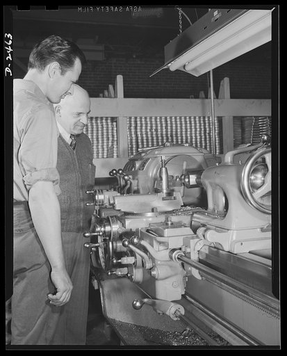 Conversion. Floor waxer plant. Through the skill and ingenuity of the entire personnel of this small Eastern manufacturing firm, machinery formerly used in production of floor waxers has been converted to production of war essentials. Pictured here are the shop's owner (right) and night foreman, bot