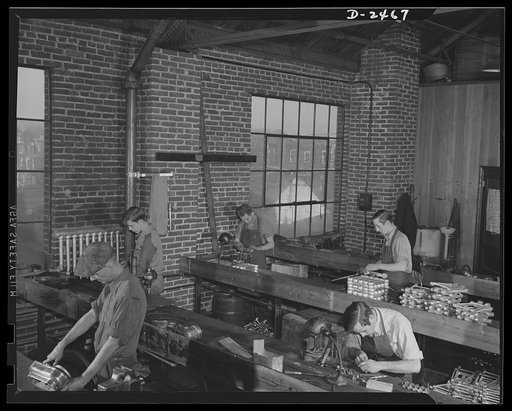 Conversion. Floor waxer plant. These bench operators of a small Eastern floor-waxing equipment company are working on defense production, all but the worker at left. He's completing assembly of one of the few waxing machines left in the factory. Floorola Products Inc., York, Pennsylvania