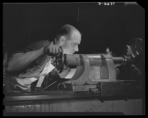 Conversion. Floor waxer plant. He's not drawing a bead on an enemy ship, but he's hitting at the Axis just the same. Formerly a Work Projects Administration timekeeper (WPA), this employee of a small Eastern manufacturing firm is now producing small parts for America's war machine, due to the compan