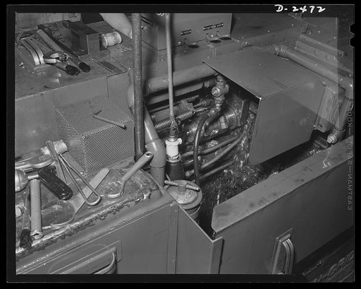 Two new tools were set in the New Britain-Gridley lathe, pictured above, to adapt it for the cutting of twenty-millimeter shell booster parts. The new parts are an eccentric spindle, which may be seen attached to a driving rod in the center of the machine, and a thread rolling attachment. In peaceti