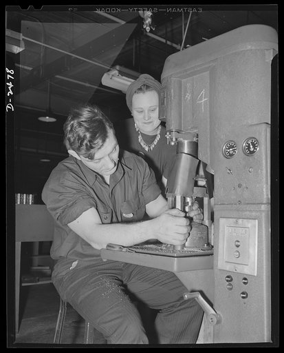 Women in defense. This Middlewestern plant has converted not only its machinery but also its skilled labor force from the peacetime production of electric fans and motors to the war production of twenty-millimeter shell boosters. Here a veteran employee of the plant's experimental division teaches a