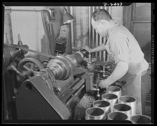 Conversion. Food machinery plant. Cutting of spouts for anti-tanks guns such as those shown in the foreground is the present work of this lathe, formerly used in the production of cube steak machines in a New England plant which is now turning out a number of parts for war machinery on subcontract. 