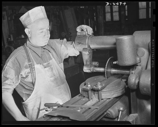 Conversion. Food machinery plant. Operator of this universal milling machine is John J. Morris shown here cutting steel disc covers for his company's normal product--cube steak machines. Today, Morris used the same machine adapted to war subcontract work- -the cutting of large hexagonal nuts for a g