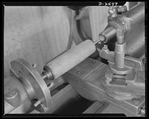 Conversion. Food machinery plant. Cutting of spouts for anti-tank guns is the present work of this lathe, shown here at its former job--shaping of wooden rollers used with a belt control to carry steaks into the cube steak machine which is this New England plant's normal product. Conversion of this 