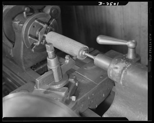 Conversion. Food machinery plant. Cutting of spouts for anti-tank guns is the present work of this lathe, shown here at its former job--shaping of wooden rollers used with a belt control to carry steaks into the cube steak machine which is this New England plant's normal product. Conversion of this 