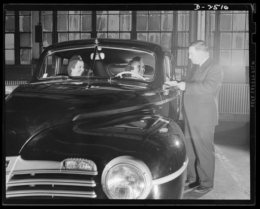 Conversion. Automobile industry. Goodbye to all this--for the duration anyway. The last lone car leaves the factory before conversion of this plant to war production. The Plymouth Company, Chrysler Corporation, Detroit, Michigan