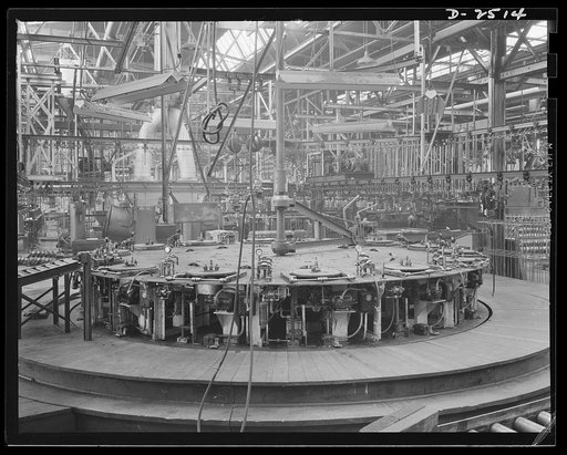 Conversion. Automobile industry. Unless special war work can be secured, this machine, which formerly put 750 tires per hour on automobile wheels, will have to be restored. To convert an auto assembly plant to war work, much of the special-purpose machinery, special conveyors, and overhead equipment