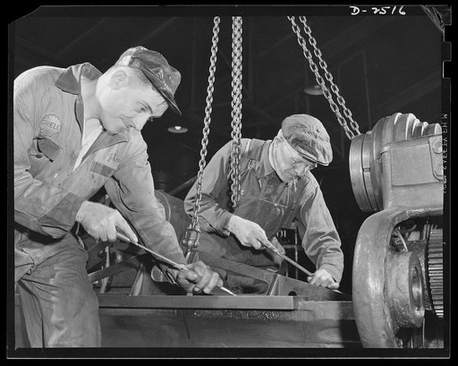 Conversion. Automobile industry. Directly contributing to victory, these tow automobile workers are starting conversion of a lathe so that it can accomodate tank parts. The Plymouth Company, Chrysler Corporation, Detroit, Michigan