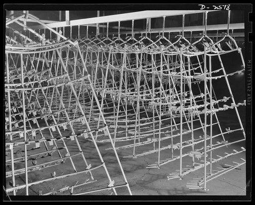 Conversion. Automobile industry. These racks once carried car hoods through the paint shop of a huge automobile factory. With the factory's conversion to production of war essentials, these and other types of special equipment must be put in storage. The Plymouth Company, Chrysler Corporation, Detro