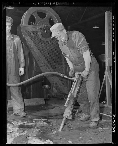 Conversion. Automobile industry. Floors which once held auto assembly equipment being torn up to prepare for installation of heavy war production equipment. The Plymouth Company, Chrysler Corporation, Detroit, Michigan