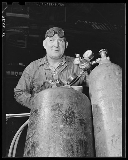 Conversion. Automobile industry. An acetylene torch is rolled into place with a big job scheduled for it, the dismantling of auto production equipment in an automobile factory, so that conversion to war production can begin. The Plymouth Company, Chrysler Corporation, Detroit, Michigan
