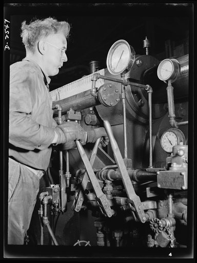 Conversion. Copper and brass processing. This worker is at the controls of an extruding machine, a powerful piece of apparatus in a brass and copper mill that pushes billets of metal usually heated red hot, through a die to form rods, tubes, angles, channels and other shapes. Chase Brass and Copper 
