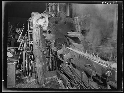 Conversion. Copper and brass processing. This picture shows brass rod coming from the extrusion machine. Red hot brass billets (solid cylindrical castings) are pushed by tremendous force through a steel die in the extrusion press to form rods of various shapes, or hollow shells that are subsequently