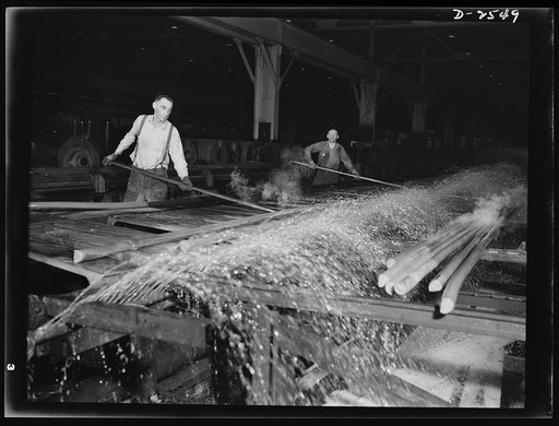 Conversion. Copper and brass processing. As extruded rod comes from the extrusion machine, it is too hot to handle. It is put under a cold water spray, then sent to the saws to be cut to shorter lengths for further operations. Chase Copper and Brass Company, Euclid, Ohio