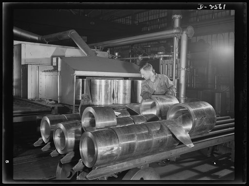 Conversion. Copper and brass processing. This is the inlet end of a conveyor furnace. The rolls of strip brass and copper ride through the furnace on a conveyor, and when the metal comes out the other side it is annealed, and ready to be worked; that is rolled to a thinner gauge, or stamped into cup