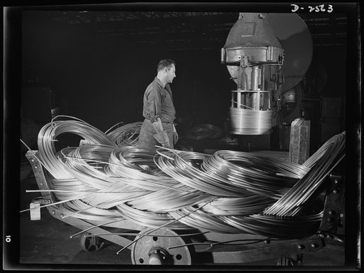 Conversion. Copper and brass processing. This is an inverted bull clock, a modern piece of equipment in a brass and copper mill for drawing large diameter wire. As the wire leaves the machine, it is automatically coiled for easy handling. Most frequently it is redrawn to smaller diameters, though th