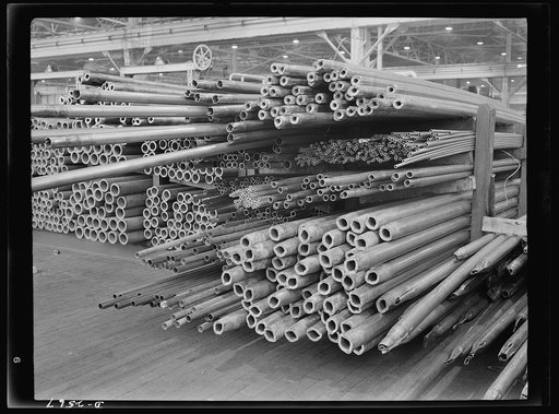 Conversion. Copper and brass processing. Stocks of partially completed lengths of seamless copper tube in many sizes. These have still to go through several more draws through dies on drawbenches. Each draw reduces them in diameter and wall thickness, and lengthens them out. Then, before the tubes l
