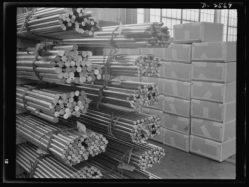 Conversion. Copper and brass processing. Bundles of various sizes brass, copper, and bronze rod in the shipping room of a brass and copper mill. These will be manufactured into shafting for boats, or sawed into short lengths and machined to make fuse components or any of hundreds of solid brass part