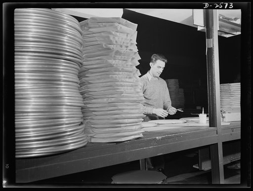 Conversion. Copper and brass processing. Packing coils of refrigeration tubing in paper containers. Because it is important to keep dirt and moisture from refrigeration tube, it is packaged in individual envelopes. Chase Copper and Brass Company, Euclid, Ohio