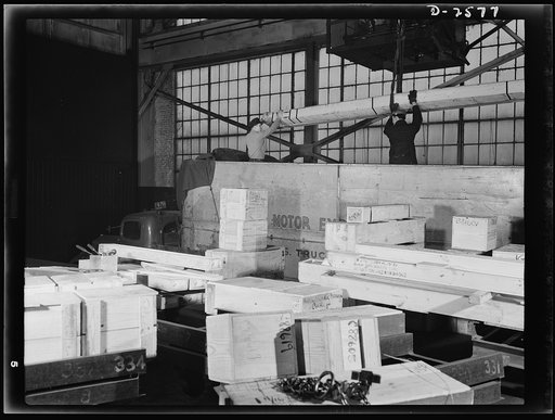 Conversion. Copper and brass processing. This is the busy shipping platform of a brass mill. An electric crane is lowering a case of tubes on a truck. Other finished brass and copper rod, wire, and tubes are on the platform packed and ready to ship. Chase Copper and Brass Company, Euclid, Ohio