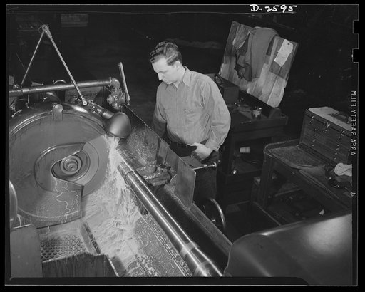 Conversion. Safe and lock company. Guns to blast the Axis from the earth. A factory which formerly produced locks and safes now produces thirty-seven-millimeter guns and gun mounts. Here the grinder goes into action on a gun. York Safe and Lock Company, York, Pennsylvania