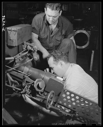 Conversion. Safe and lock company. Workers give the once-over to thirty-seven-millimeter gun mounts being assembled in a factory which formerly manufactured safes and locks for civilian use. York Safe and Lock Company, York, Pennsylvania
