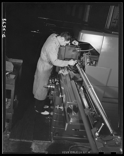 Conversion. Safe and lock company. Thirty-seven-millimeter gun parts go through the thread grinder in a factory now devoted to production of these weapons. The factory has been converted to this production from the manufacture of locks and safes. York Safe and Lock Company, York, Pennsylvania