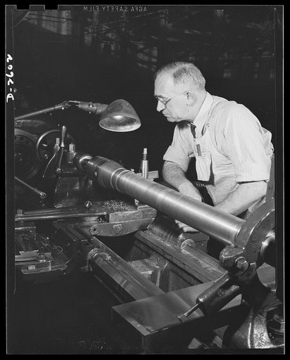 Conversion. Safe and lock company. He ran a lathe in '17, and he's running one for Uncle Sam again. Harry Melhorn is one of America's soldiers on the second line of defense; he's producing thirty-seven-millimeter guns in a factory which formerly made safes and locks. York Safe and Lock Company, York